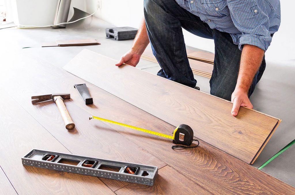 A man installing kitchen floor